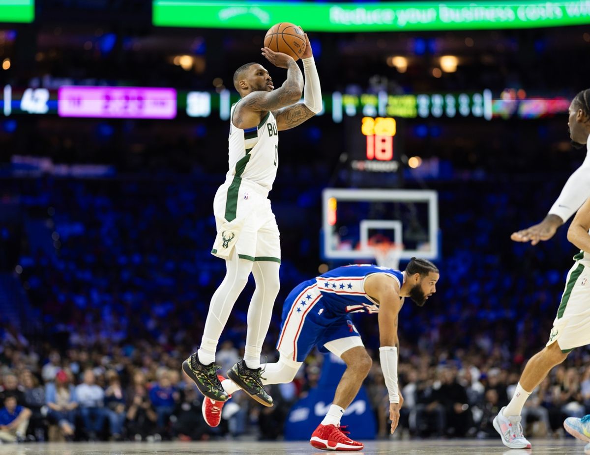 Oct 23, 2024; Philadelphia, Pennsylvania, USA; Milwaukee Bucks guard Damian Lillard (0) shoots over Philadelphia 76ers forward Caleb Martin (16) during the second quarter at Wells Fargo Center. Mandatory Credit: Bill Streicher-Imagn Images