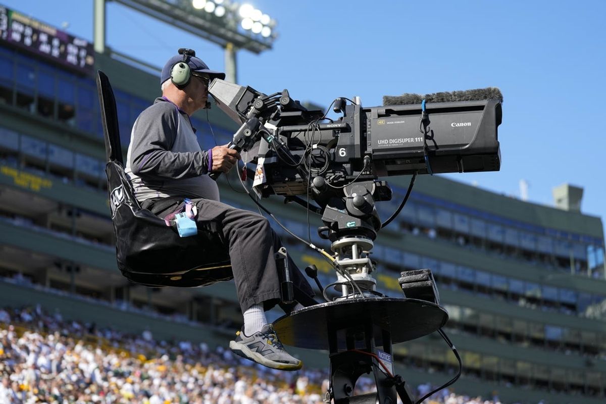 Oct 20, 2024; Green Bay, Wisconsin, USA;  General view of a television camera operator during the game between the Houston Texans and Green Bay Packers at Lambeau Field. Mandatory Credit: Jeff Hanisch-Imagn Images