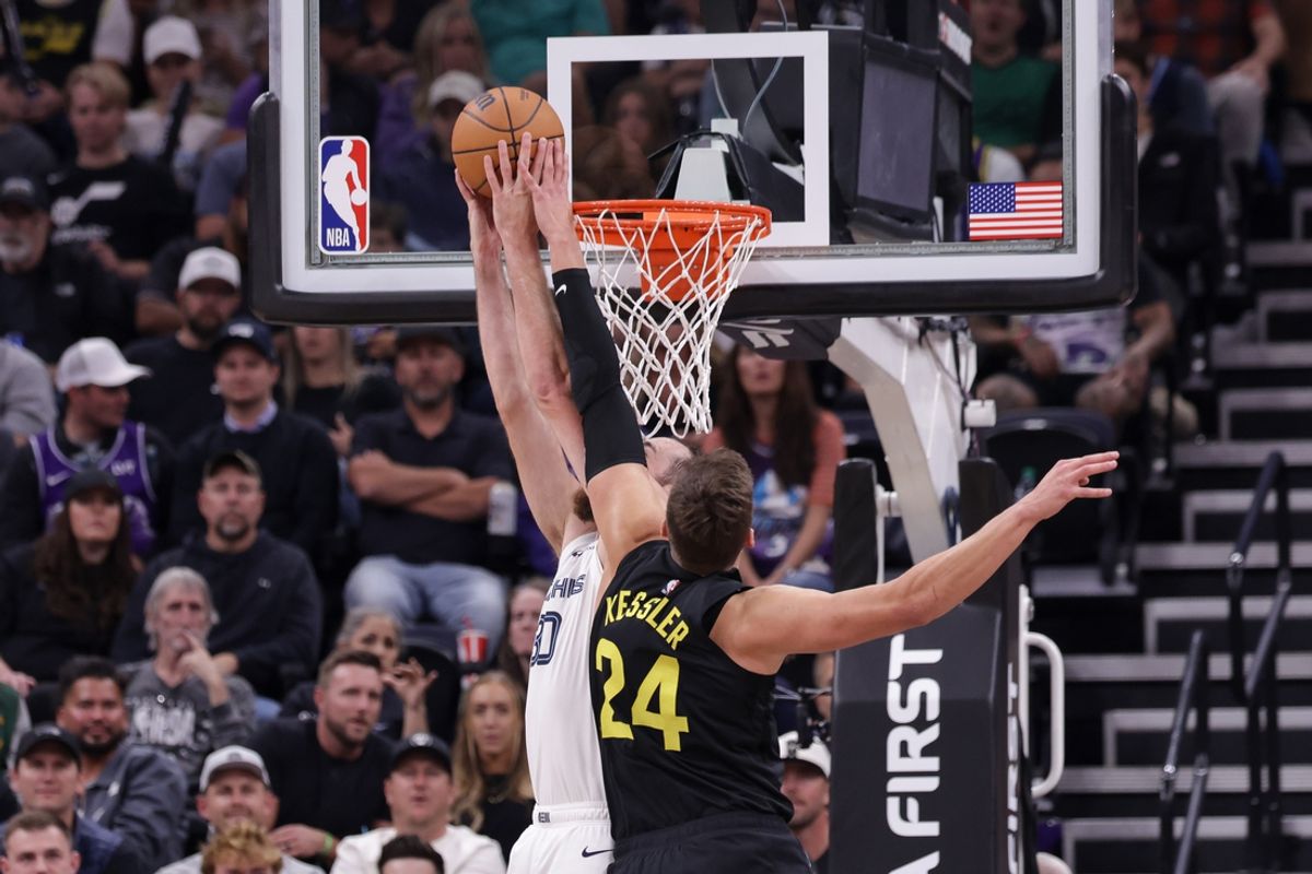 Oct 23, 2024; Salt Lake City, Utah, USA; Utah Jazz center Walker Kessler (24) fouls Memphis Grizzlies center Jay Huff (30) while shooting during the second quarter at Delta Center. Mandatory Credit: Chris Nicoll-Imagn Images