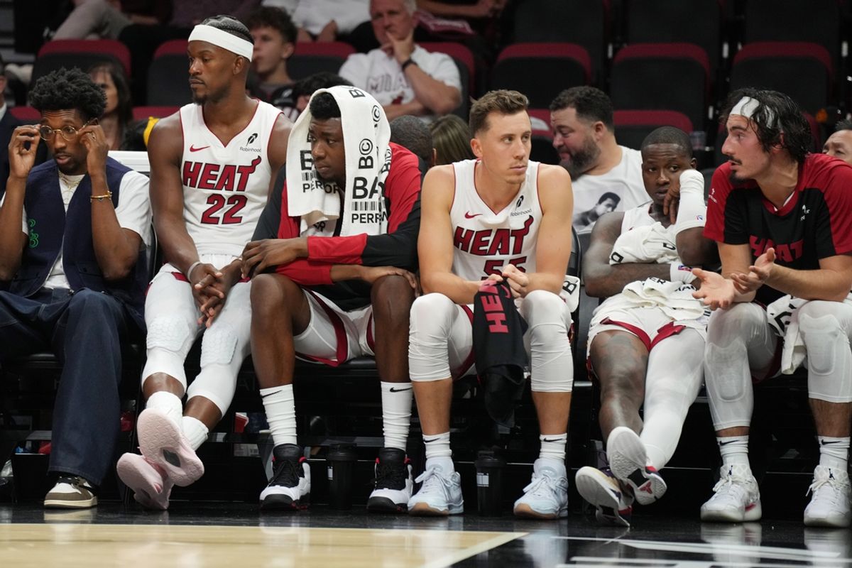 Oct 23, 2024; Miami, Florida, USA;  Miami Heat forward Jimmy Butler (22) and the Heat bench look on late in the game with the score out of reach to the Orlando Magic at Kaseya Center. Mandatory Credit: Jim Rassol-Imagn Images
