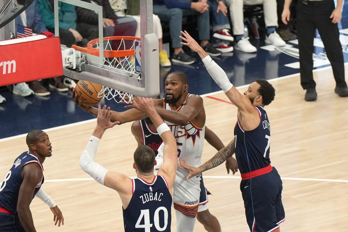 Oct 23, 2024; Inglewood, California, USA; Phoenix Suns forward Kevin Durant (35) shoots the ball against LA Clippers center Ivica Zubac (40) and guard Amir Coffey (7) in the first half at Intuit Dome. Mandatory Credit: Kirby Lee-Imagn Images