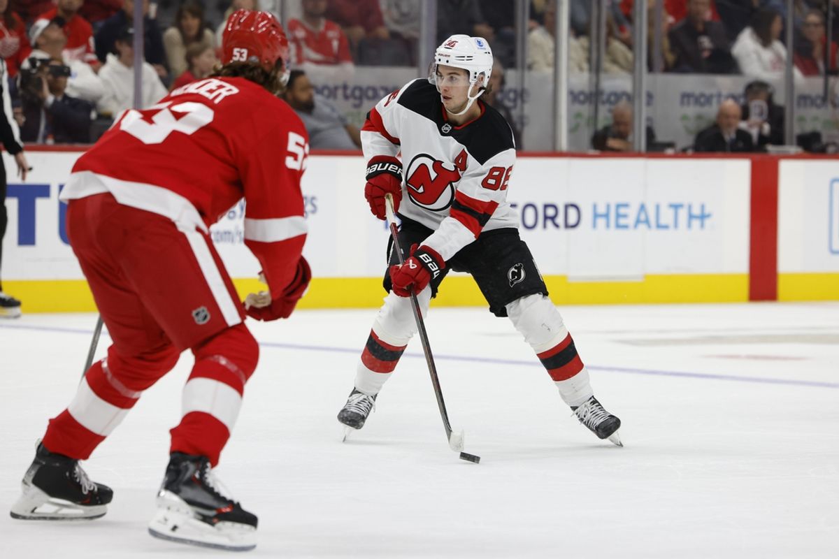 Oct 24, 2024; Detroit, Michigan, USA;  New Jersey Devils center Jack Hughes (86) skates with the puck defended by Detroit Red Wings defenseman Moritz Seider (53) in the first period at Little Caesars Arena. Mandatory Credit: Rick Osentoski-Imagn Images