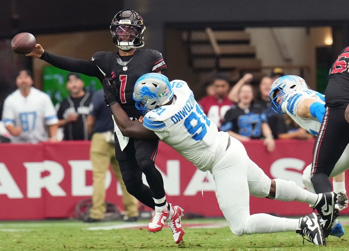 Arizona Cardinals quarterback Kyler Murray (1) releases the ball as he is dragged down by Detroit Lions defensive lineman Levi Onwuzurike (91) at State Farm Stadium in Glendale on Sept. 22, 2024.