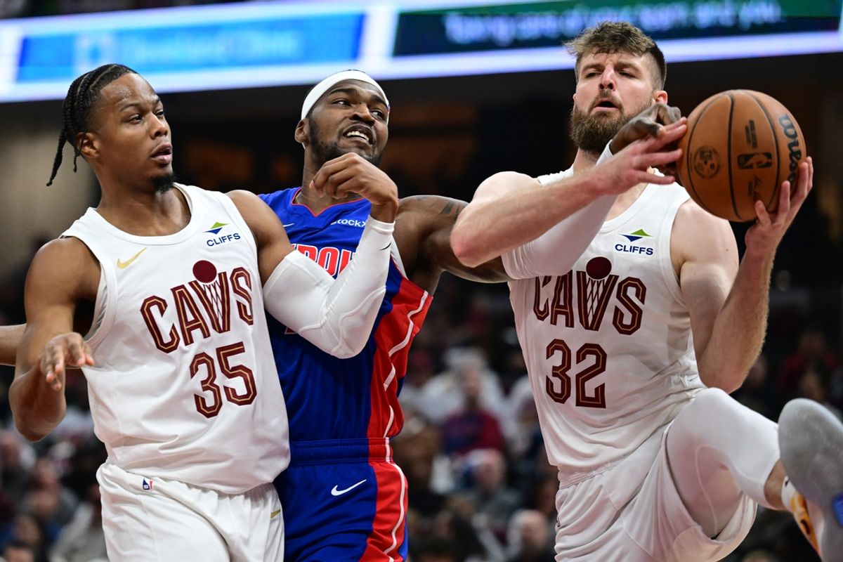 Oct 25, 2024; Cleveland, Ohio, USA; Cleveland Cavaliers forward Dean Wade (32) goes for a rebound against Detroit Pistons forward Paul Reed (7) as forward Isaac Okoro (35) also defends during the first half at Rocket Mortgage FieldHouse. Mandatory Credit: Ken Blaze-Imagn Images