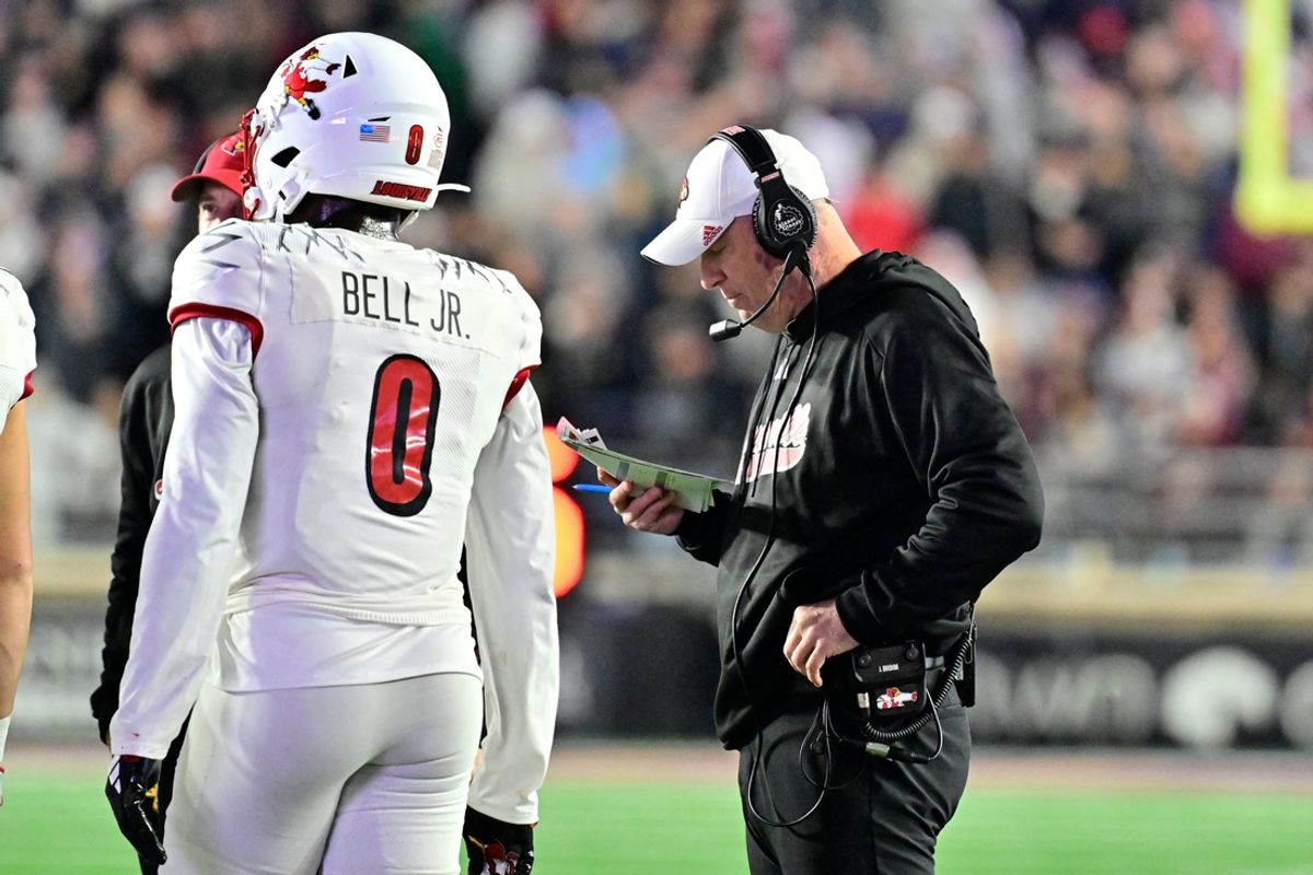 Oct 25, 2024; Chestnut Hill, Massachusetts, USA; Louisville Cardinals head coach Jeff Brohm looks over his play card during the first half against the Boston College Eagles at Alumni Stadium. Mandatory Credit: Eric Canha-Imagn Images