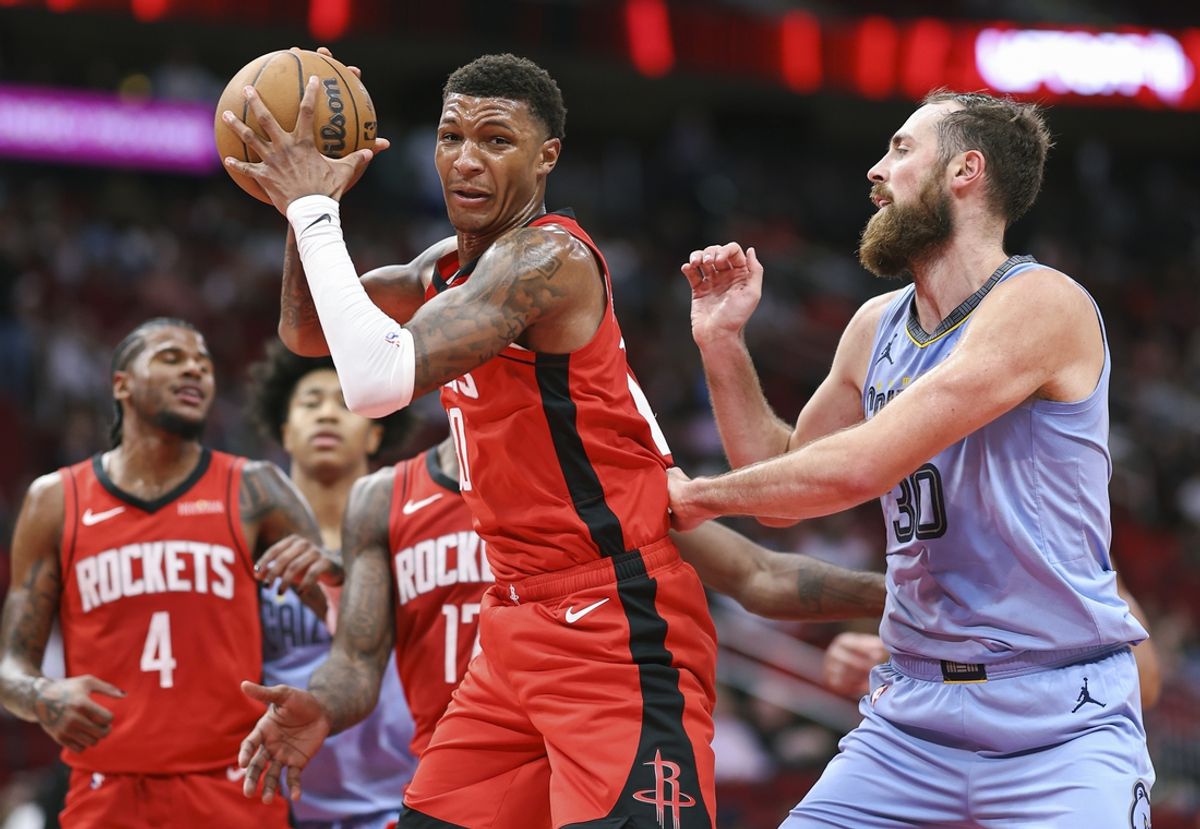 Oct 25, 2024; Houston, Texas, USA; Houston Rockets forward Amen Thompson (1) grabs a rebound away from Memphis Grizzlies center Jay Huff (30) during the second quarter at Toyota Center. Mandatory Credit: Troy Taormina-Imagn Images