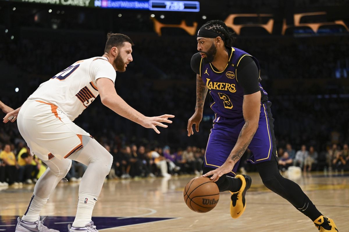 Oct 25, 2024; Los Angeles, California, USA; Los Angeles Lakers forward Anthony Davis (3) against Phoenix Suns center Jusuf Nurkic (20) during the first half at Crypto.com Arena. Mandatory Credit: Jonathan Hui-Imagn Images