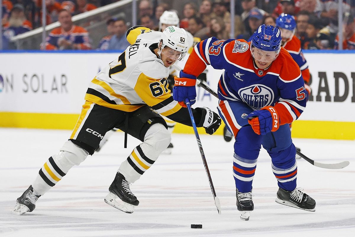 Oct 25, 2024; Edmonton, Alberta, CAN; Pittsburgh Penguins forward Rickard Rakell (67) tries to knock the puck away from Edmonton Oilers forward Jeff Skinner (53) during the third period at Rogers Place. Mandatory Credit: Perry Nelson-Imagn Images