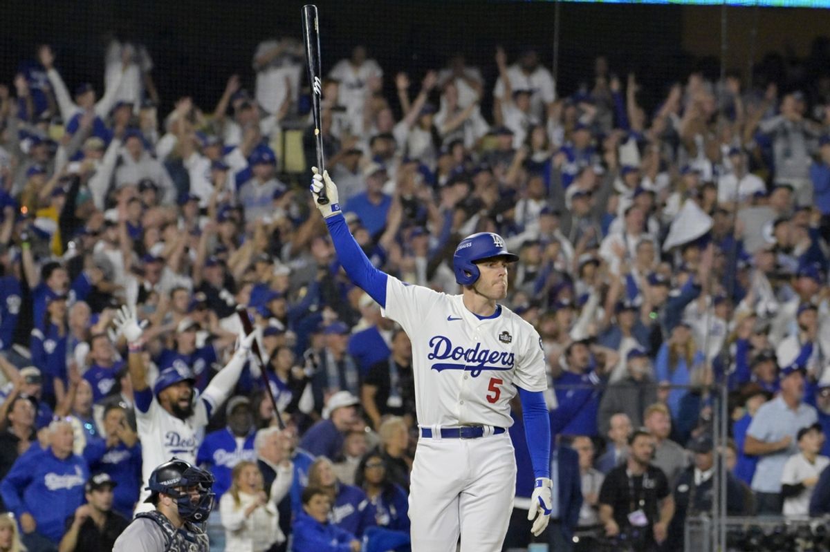 Oct 25, 2024; Los Angeles, California, USA; Los Angeles Dodgers first baseman Freddie Freeman (5) celebrates after hitting a grand slam home run in the tenth inning against the New York Yankees during game one of the 2024 MLB World Series at Dodger Stadium. Mandatory Credit: Jayne Kamin-Oncea-Imagn Images
