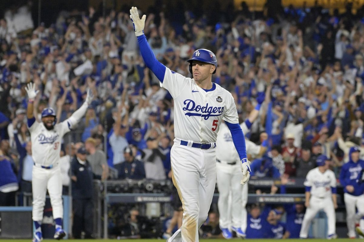 Oct 25, 2024; Los Angeles, California, USA; Los Angeles Dodgers first baseman Freddie Freeman (5) celebrates after hitting a grand slam home run in the tenth inning against the New York Yankees during game one of the 2024 MLB World Series at Dodger Stadium. Mandatory Credit: Jayne Kamin-Oncea-Imagn Images