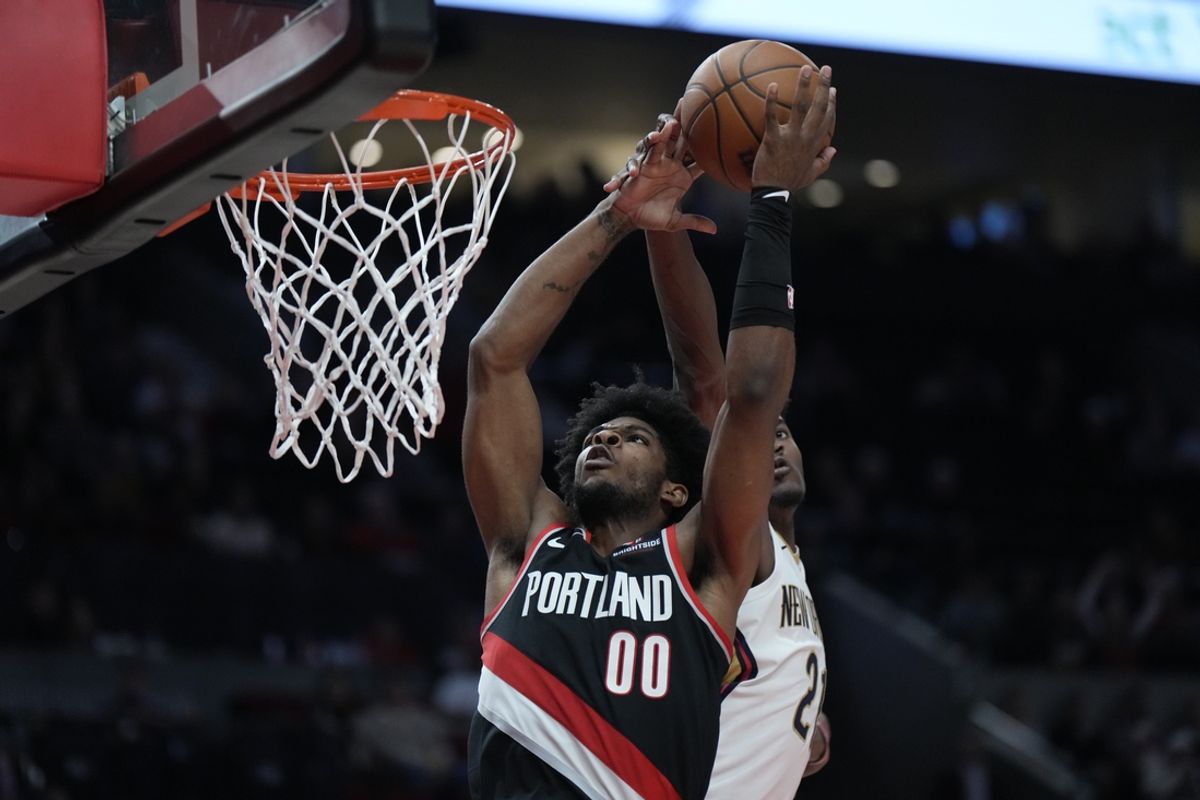 Oct 25, 2024; Portland, Oregon, USA; Portland Trail Blazers guard Scoot Henderson (00) drives to the basket past New Orleans Pelicans center Yves Missi (21) during the second half at Moda Center. Mandatory Credit: Soobum Im-Imagn Images