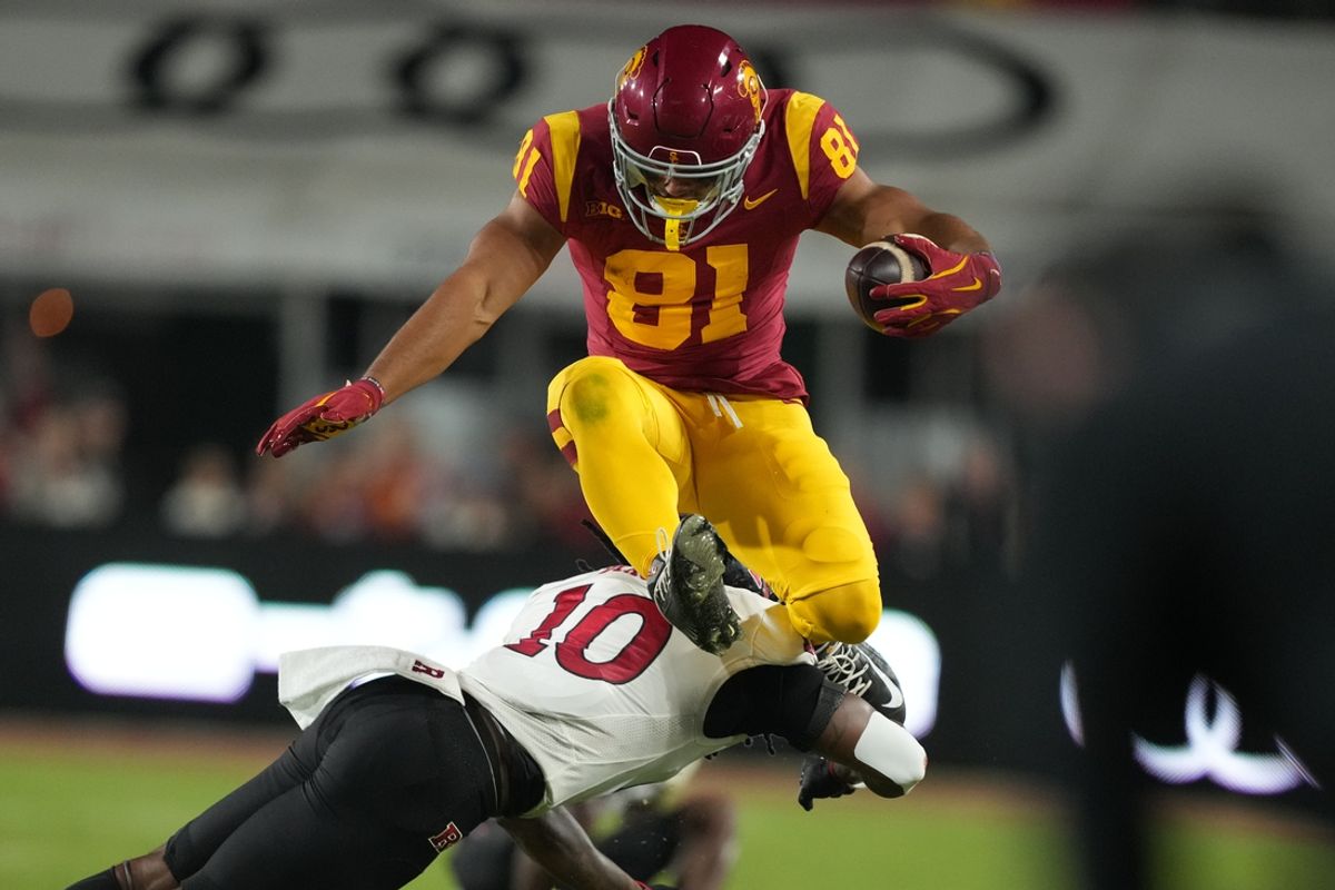Oct 25, 2024; Los Angeles, California, USA; Southern California Trojans wide receiver Kyle Ford (81) hurdles Rutgers Scarlet Knights defensive back Flip Dixon (10) in the first half at United Airlines Field at Los Angeles Memorial Coliseum. Mandatory Credit: Kirby Lee-Imagn Images