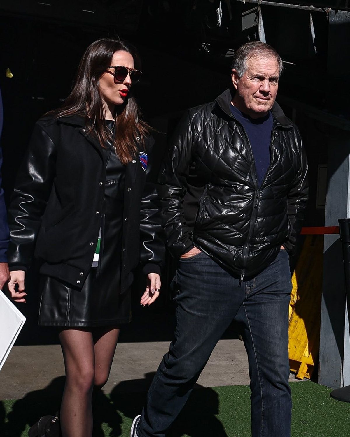 Oct 26, 2024; East Rutherford, New Jersey, USA; Former New England Patriots head coach Bill Belichick and girlfriend Jordon Hudson enter the field before the game between the Notre Dame Fighting Irish and the Navy Midshipmen at MetLife Stadium. Mandatory Credit: Vincent Carchietta-Imagn Images