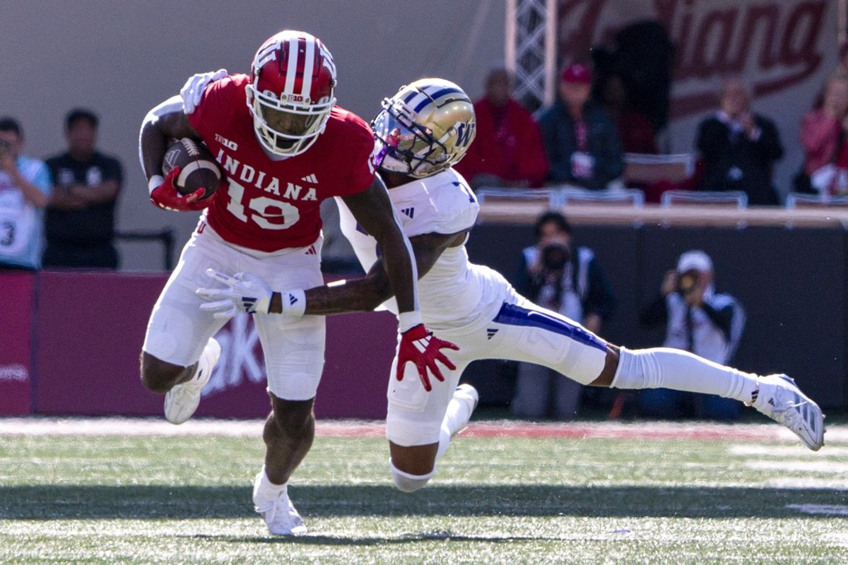 Oct 26, 2024; Bloomington, Indiana, USA; Indiana Hoosiers wide receiver Miles Cross (19) is tackled by Washington Huskies cornerback Ephesians Prysock (7) during the second quarter at Memorial Stadium. Mandatory Credit: Jacob Musselman-Imagn Images