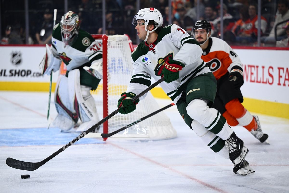 Oct 26, 2024; Philadelphia, Pennsylvania, USA; Minnesota Wild defenseman Brock Faber (7) controls the puck against the Philadelphia Flyers in the third period at Wells Fargo Center. Mandatory Credit: Kyle Ross-Imagn Images