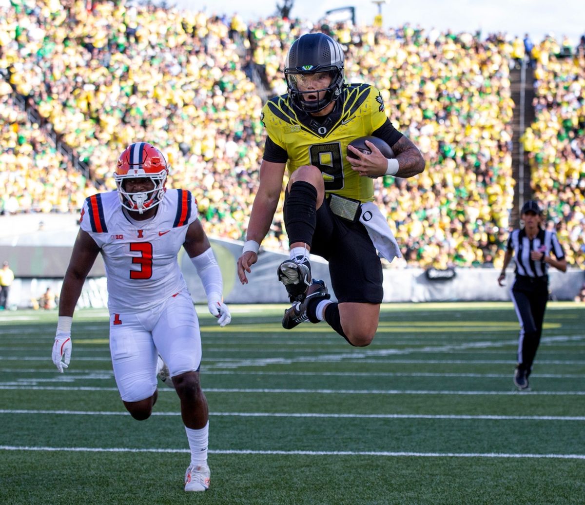Oregon quarterback Dillon Gabriel leaps into the end zone fr a touchdown during the second quarter against Illinois at Autzen Stadium.