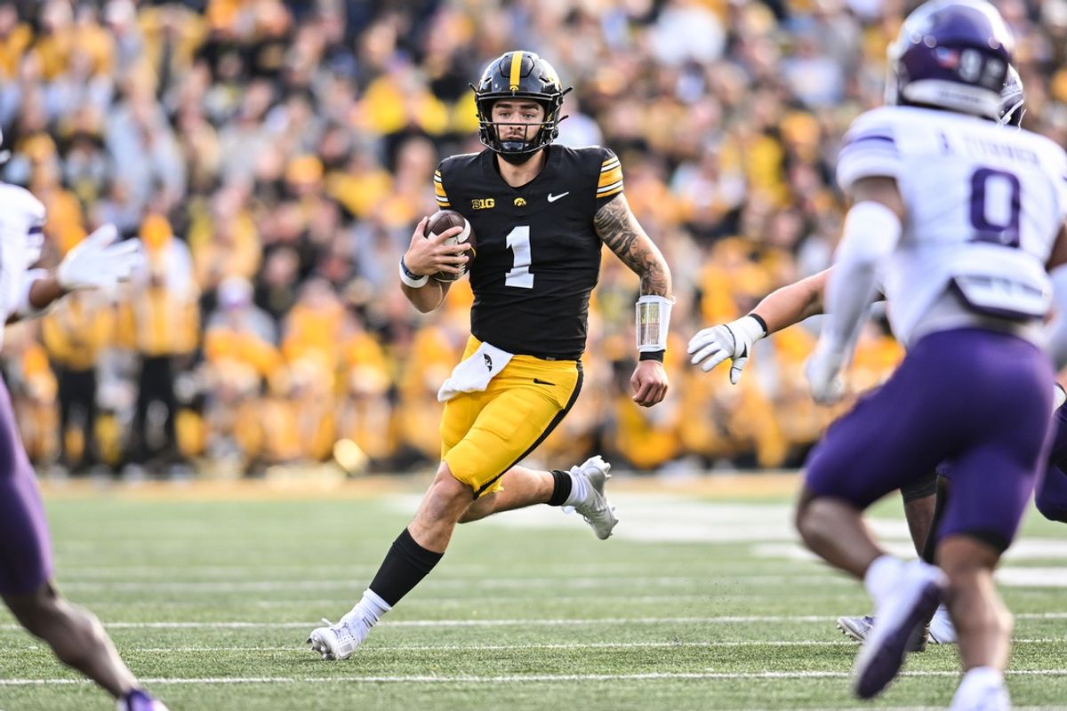 Oct 26, 2024; Iowa City, Iowa, USA; Iowa Hawkeyes quarterback Brendan Sullivan (1) runs for yardage against the Northwestern Wildcats during the second quarter at Kinnick Stadium. Mandatory Credit: Jeffrey Becker-Imagn Images