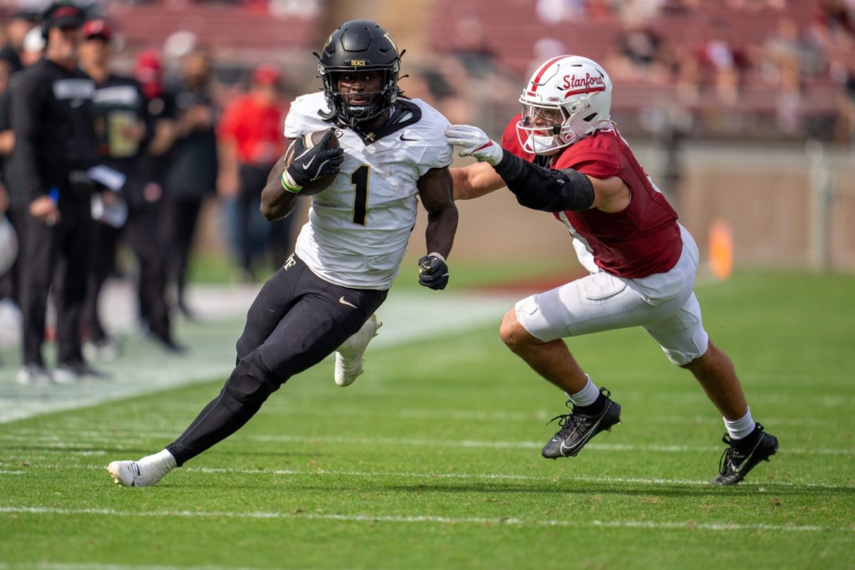 Oct 26, 2024; Stanford, California, USA;  Wake Forest Demon Deacons running back Demond Claiborne (1) breaks a tackle by Stanford Cardinal linebacker Tristan Sinclair (8) during the second quarter fr a first down at Stanford Stadium. Mandatory Credit: Neville E. Guard-Imagn Images