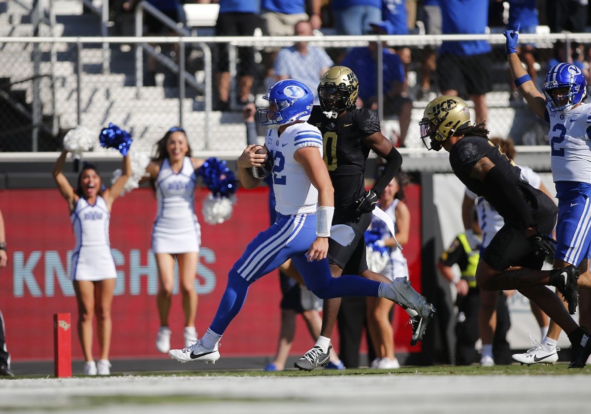 Oct 26, 2024; Orlando, Florida, USA; Brigham Young Cougars quarterback Jake Retzlaff (12) runs for a touchdown against the Central Florida Knights at FBC Mortgage Stadium. Mandatory Credit: Russell Lansford-Imagn Images