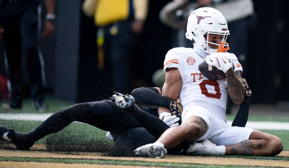 Texas Longhorns wide receiver DeAndre Moore Jr. (0) catches a touchdown while guarded by Vanderbilt Commodores safety Dontae Carter (21) during the first half of their game at FirstBank Stadium in Nashville, Tenn., Saturday, Oct. 26, 2024.