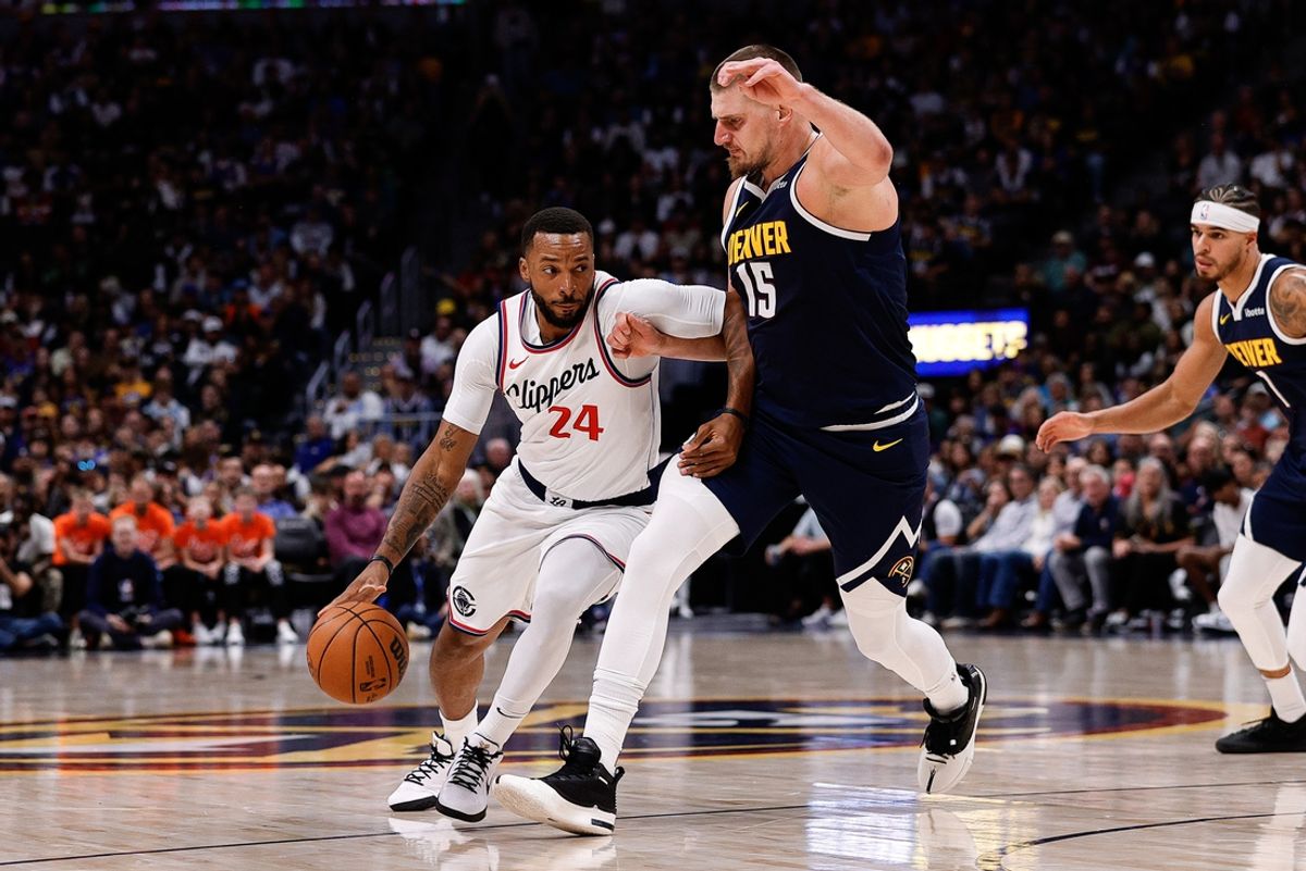 Oct 26, 2024; Denver, Colorado, USA; Los Angeles Clippers guard Norman Powell (24) controls the ball as Denver Nuggets center Nikola Jokic (15) guards in the second quarter at Ball Arena. Mandatory Credit: Isaiah J. Downing-Imagn Images