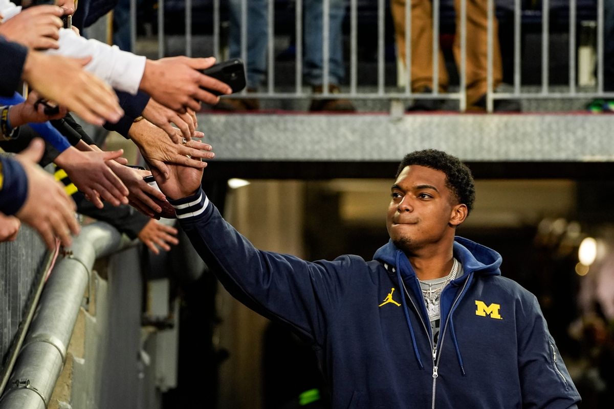 Michigan defensive back Will Johnson (2) high-fives fans during warm up before the Michigan State game at Michigan Stadium in Ann Arbor on Saturday, Oct. 26, 2024.