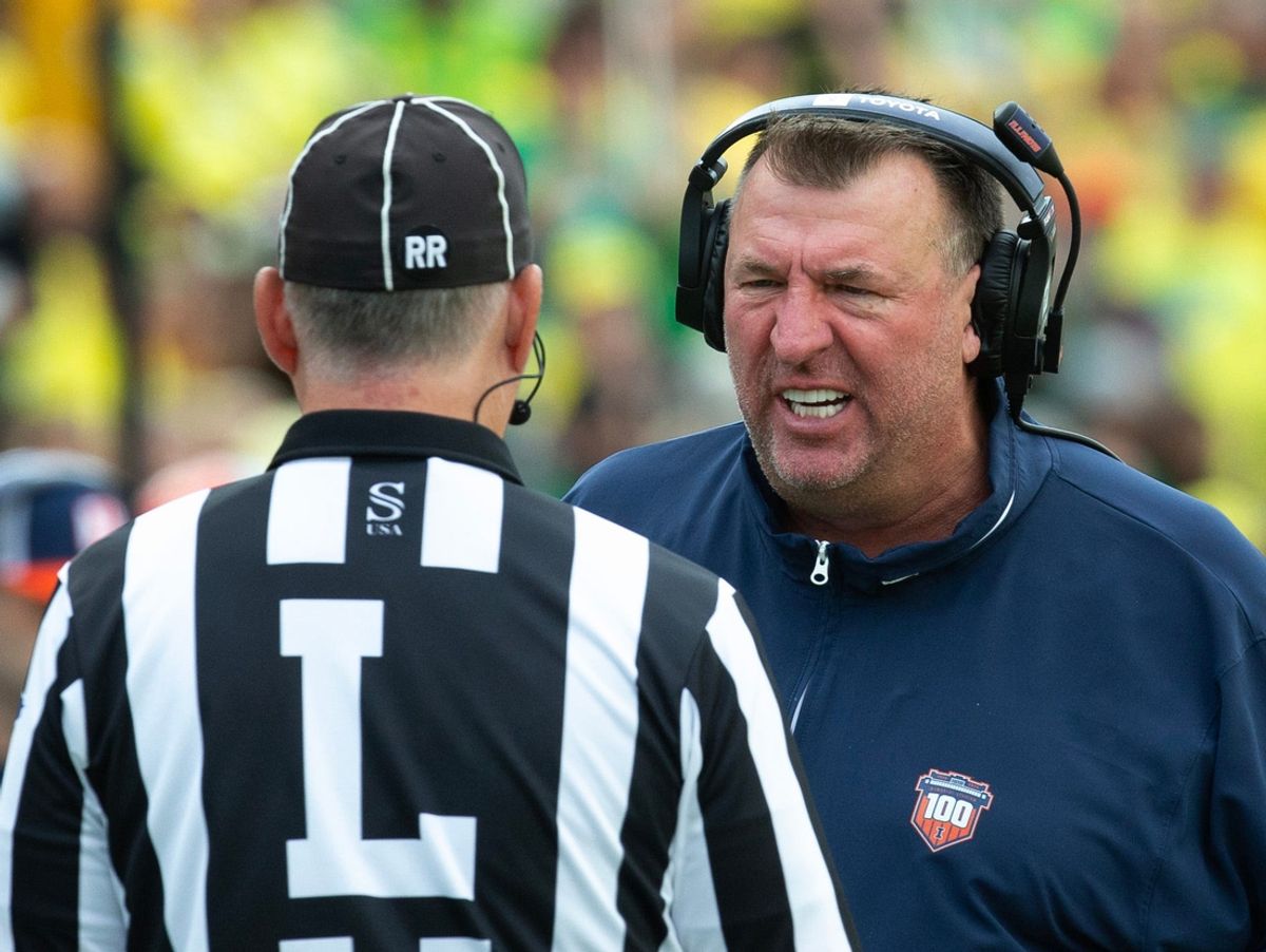 Illinois coach Bret Bielema has words with an official during the first half at Autzen Stadium.