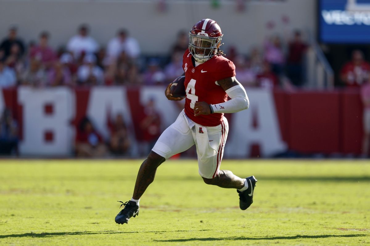 Oct 26, 2024; Tuscaloosa, Alabama, USA;  Alabama Crimson Tide quarterback Jalen Milroe (4) carries the ball for a first down against the Missouri Tigers during the first half at Bryant-Denny Stadium. Mandatory Credit: Butch Dill-Imagn Images