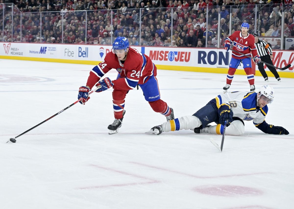 Oct 26, 2024; Montreal, Quebec, CAN; Montreal Canadiens defenseman Logan Mailloux (24) plays the puck against St.Louis Blues forward Radek Faksa (12) during the first period at the Bell Centre. Mandatory Credit: Eric Bolte-Imagn Images