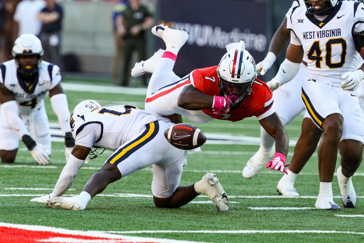 Oct 26, 2024; Tucson, Arizona, USA; Arizona Wildcats running back Quali Conley (7) fumbles the ball during the first quarter against the West Virginia Mountaineers at Arizona Stadium. Mandatory Credit: Aryanna Frank-Imagn Images