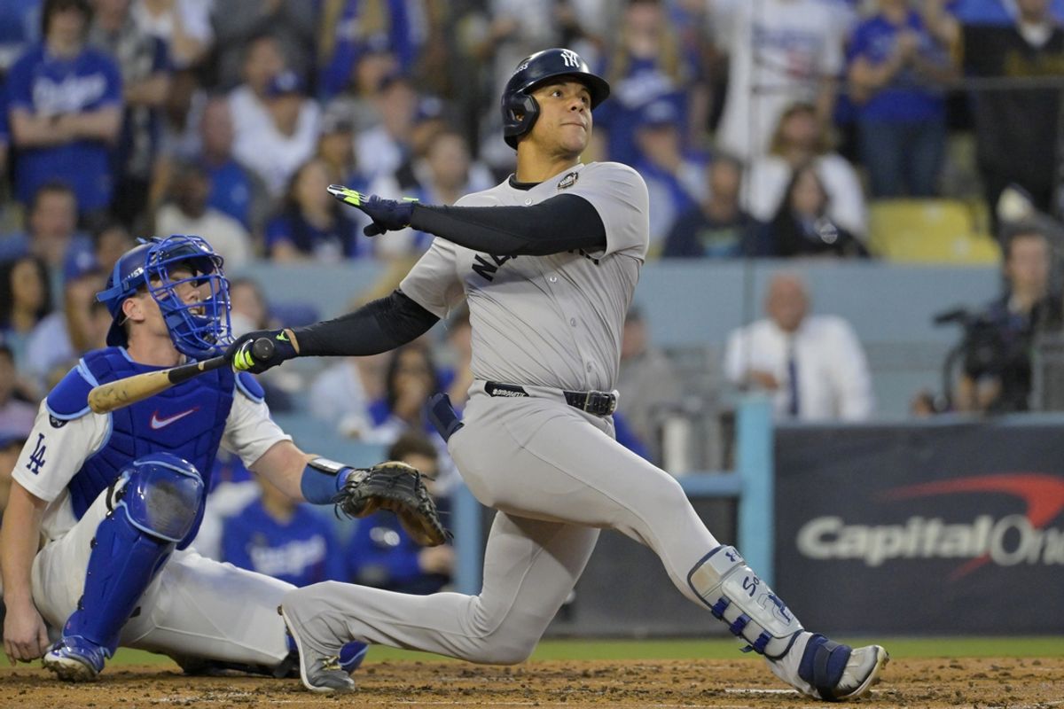 Oct 26, 2024; Los Angeles, California, USA; New York Yankees outfielder Juan Soto (22) hits a solo home run in the third inning against the Los Angeles Dodgers during game two of the 2024 MLB World Series at Dodger Stadium. Mandatory Credit: Jayne Kamin-Oncea-Imagn Images