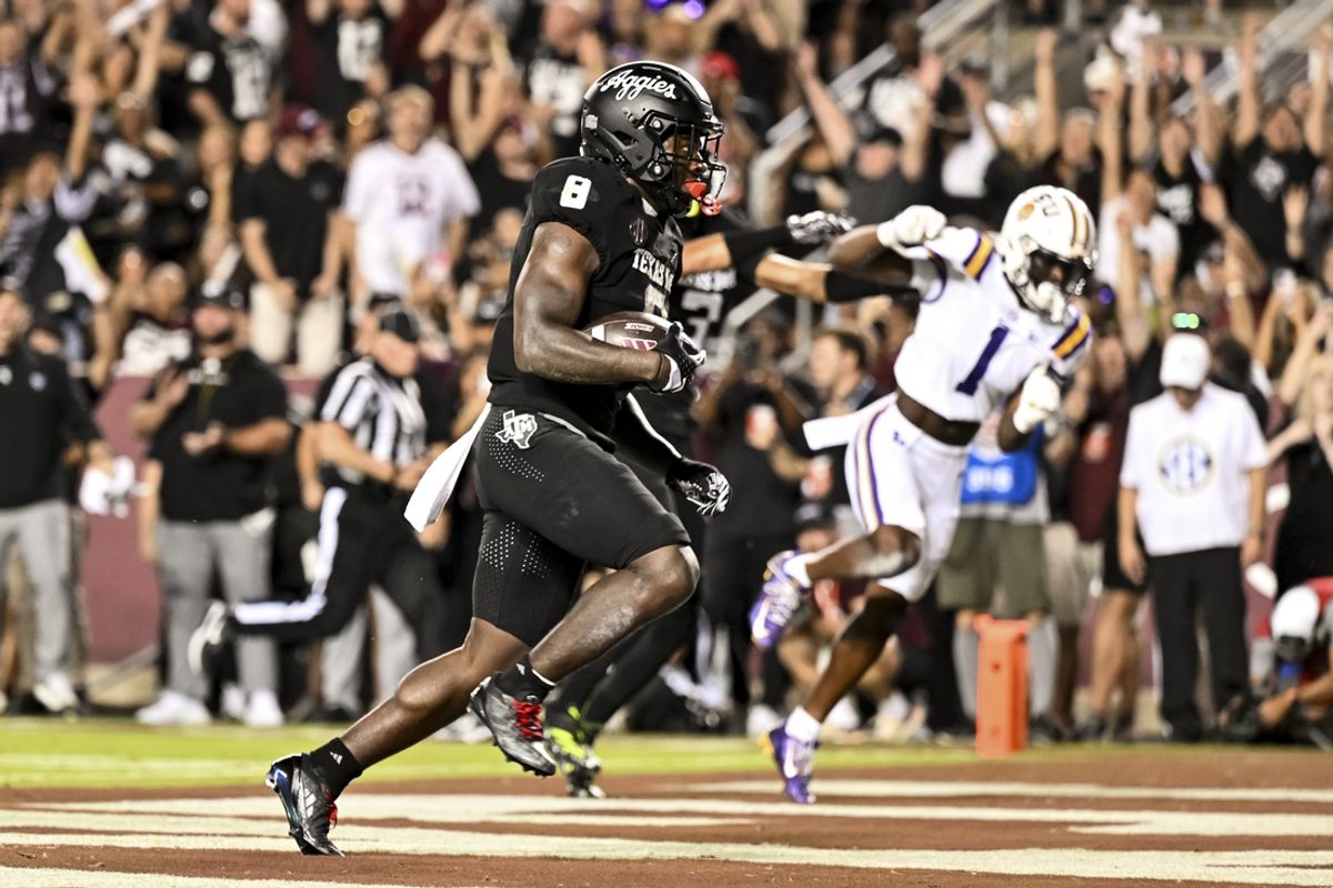 Oct 26, 2024; College Station, Texas, USA; Texas A&M Aggies running back Le'Veon Moss (8) runs the ball into the end zone for a touchdown during the first quarter against the LSU Tigers at Kyle Field. Mandatory Credit: Maria Lysaker-Imagn Images.