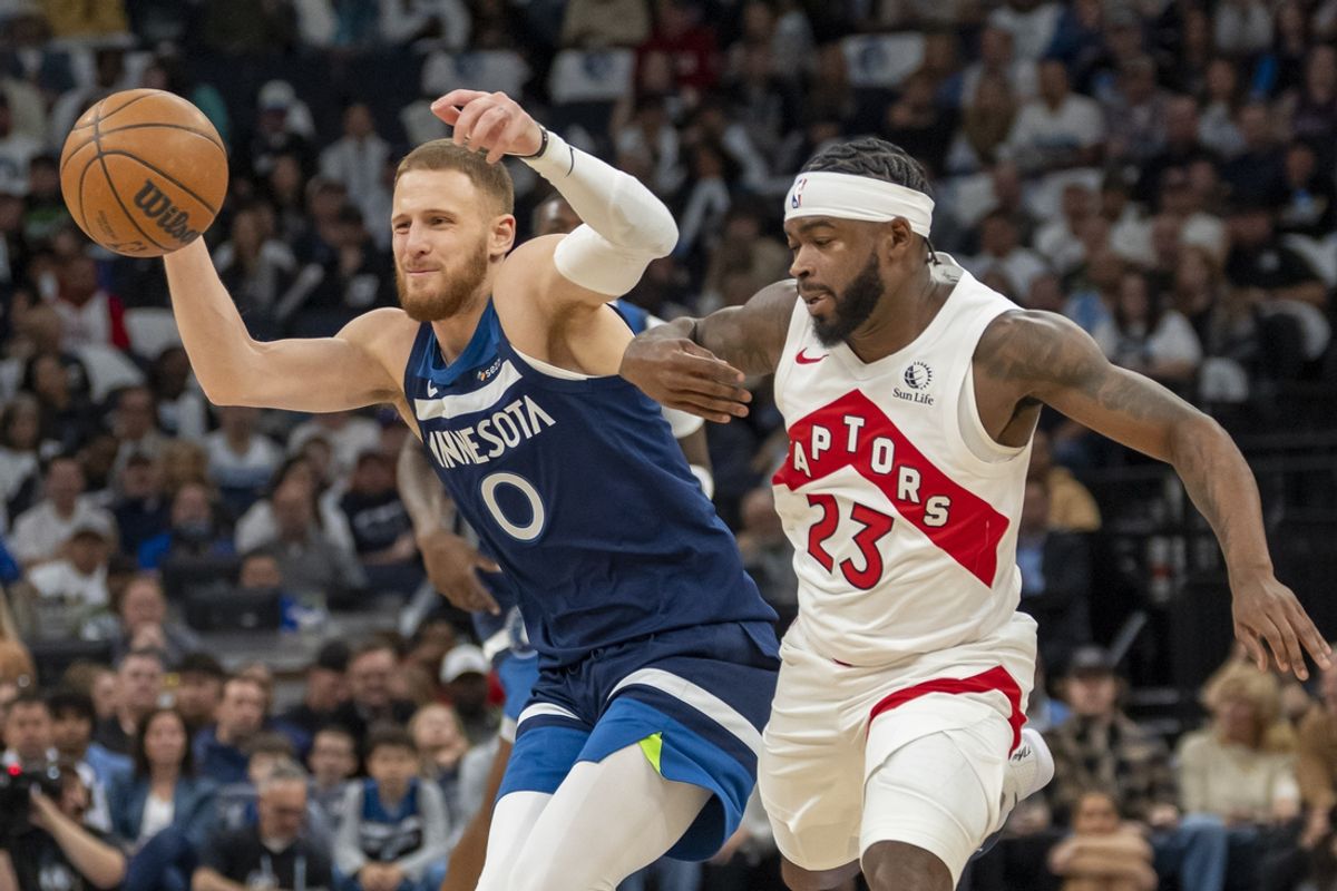 Oct 26, 2024; Minneapolis, Minnesota, USA; Minnesota Timberwolves guard Donte DiVincenzo (0) loses the ball and is fouled from Toronto Raptors guard Jamal Shead (23) in the first half at Target Center. Mandatory Credit: Jesse Johnson-Imagn Images