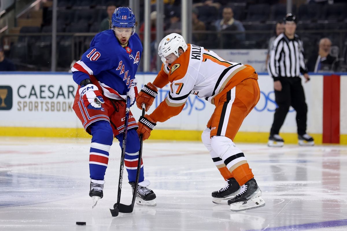 Oct 26, 2024; New York, New York, USA; Anaheim Ducks left wing Alex Killorn (17) plays the puck against New York Rangers left wing Artemi Panarin (10) during the third period at Madison Square Garden. Mandatory Credit: Brad Penner-Imagn Images