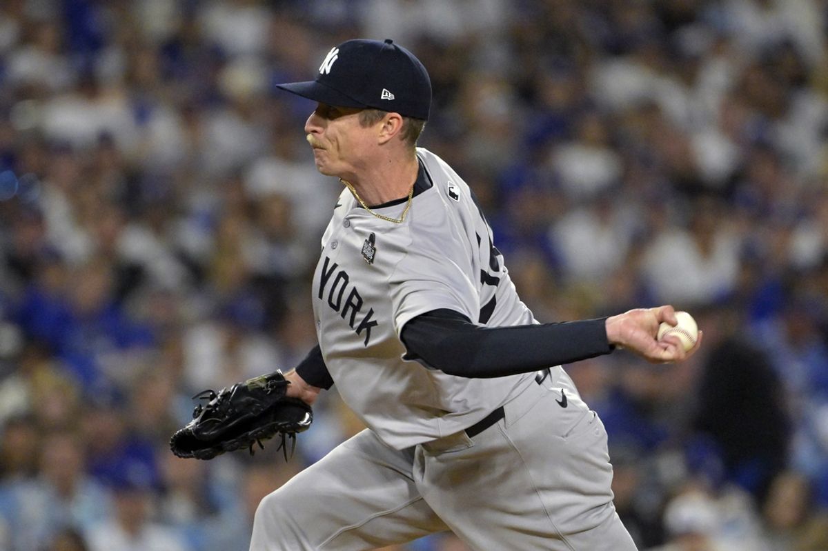 Oct 26, 2024; Los Angeles, California, USA; New York Yankees pitcher Tim Hill (54) pitches in the fifth inning against the Los Angeles Dodgers during game two of the 2024 MLB World Series at Dodger Stadium. Mandatory Credit: Jayne Kamin-Oncea-Imagn Images