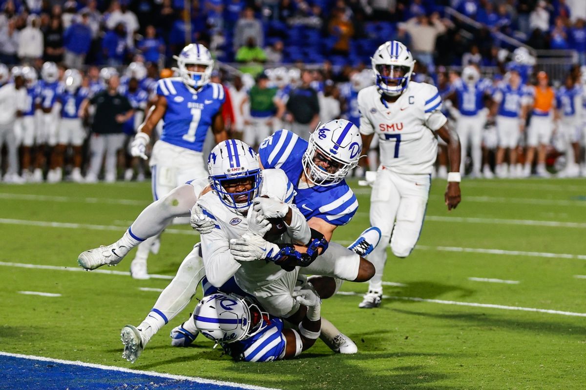 Oct 26, 2024; Durham, North Carolina, USA; Southern Methodist Mustangs running back Brashard Smith (1) is tackled by Duke Blue Devils safety Jaylen Stinson (2) and  linebacker Ozzie Nicholas (45) but scores a touchdown during the first half of the game at Wallace Wade Stadium. Mandatory Credit: Jaylynn Nash-Imagn Images