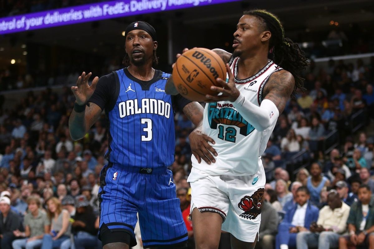 Oct 26, 2024; Memphis, Tennessee, USA; Memphis Grizzlies guard Ja Morant (12) passes the ball as Orlando Magic guard Kentavious Caldwell-Pope (3) defends during the second half at FedExForum. Mandatory Credit: Petre Thomas-Imagn Images