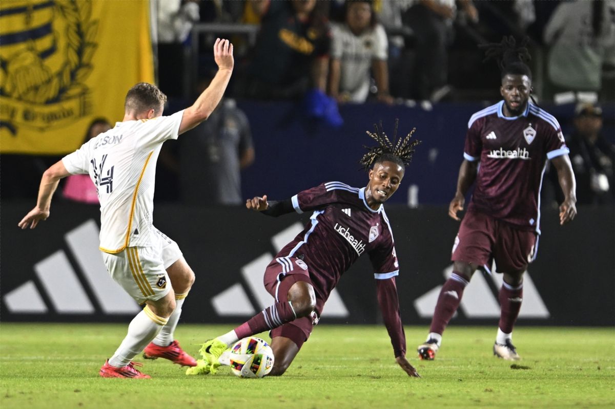 Oct 26, 2024; Carson, California, USA; Colorado Rapids forward Kevin Cabral (91) tackles the ball away from Los Angeles Galaxy defender John Nelson (14)  in the first half in a 2024 MLS Cup Playoffs Round One match at Dignity Health Sports Park. Mandatory Credit: Alex Gallardo-Imagn Images