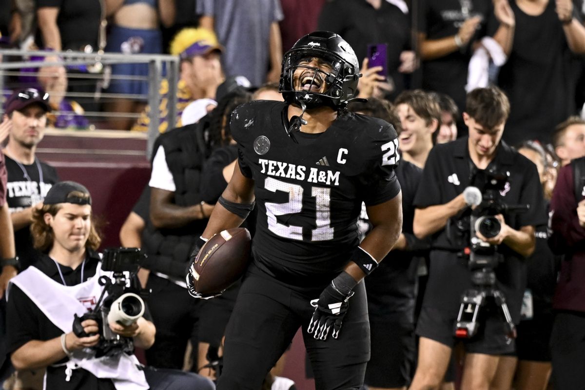 Oct 26, 2024; College Station, Texas, USA; Texas A&M Aggies linebacker Taurean York (21) reacts after catching the ball for an interception in the fourth quarter against the LSU Tigers at Kyle Field. Mandatory Credit: Maria Lysaker-Imagn Images.