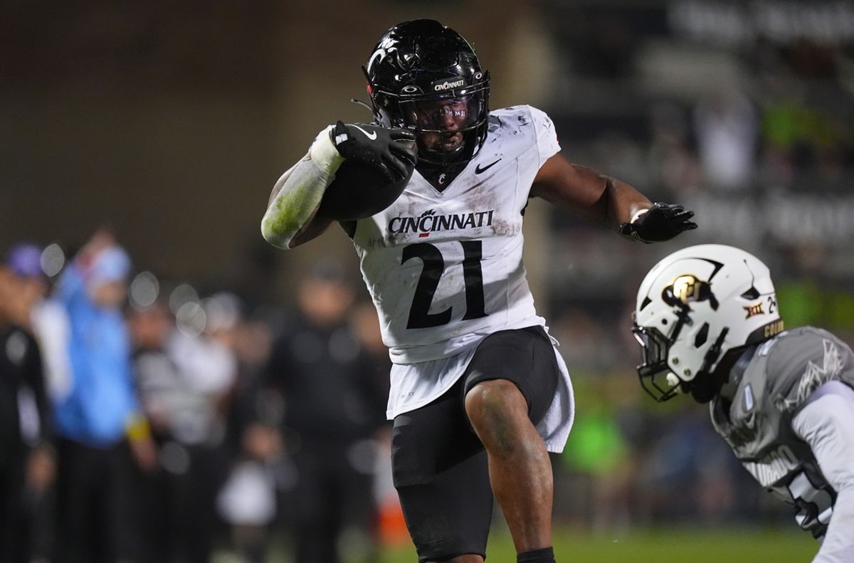 Oct 26, 2024; Boulder, Colorado, USA; Cincinnati Bearcats running back Corey Kiner (21) carries the ball in the fourth quarter against the Colorado Buffaloes at Folsom Field. Mandatory Credit: Ron Chenoy-Imagn Images