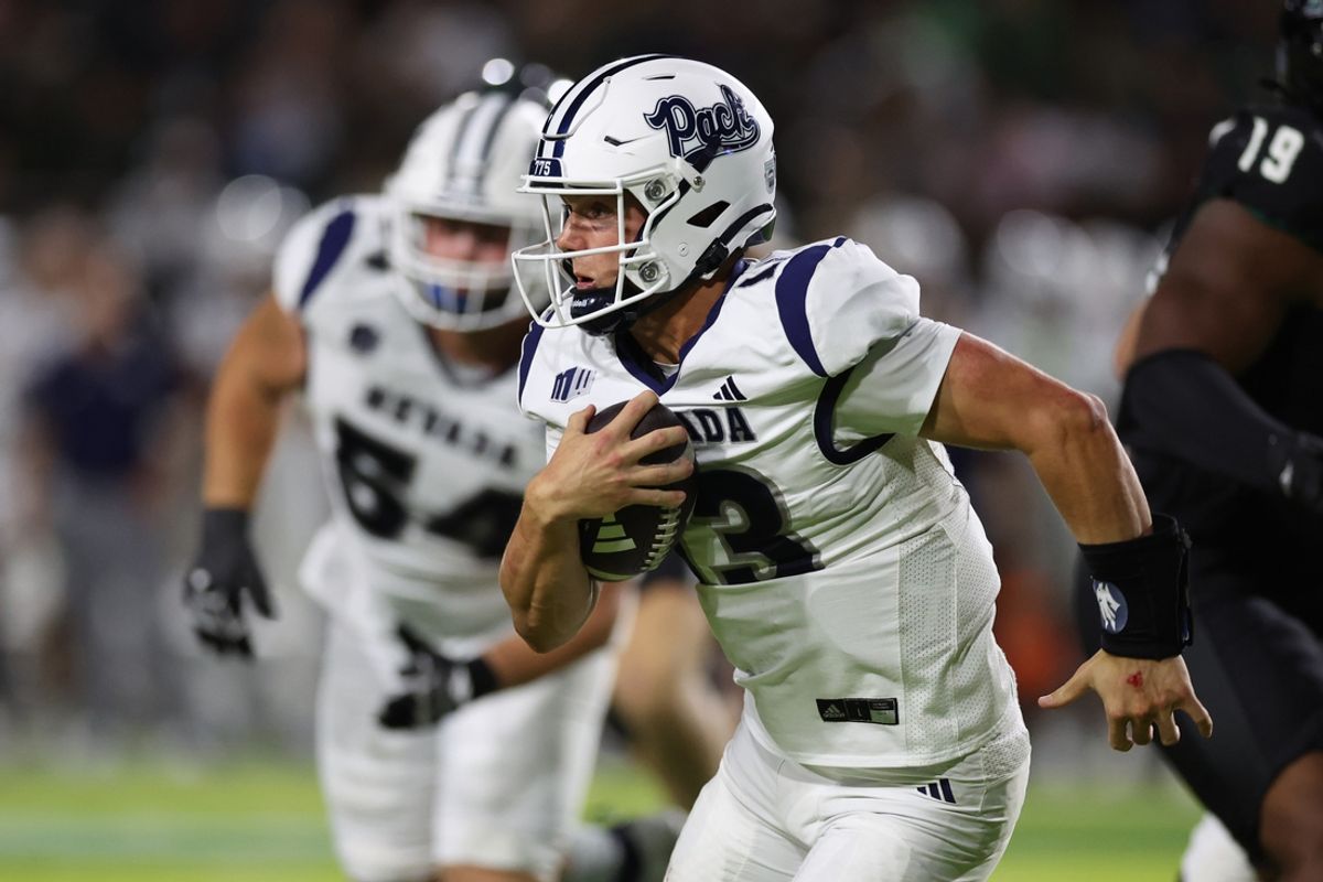 Oct 26, 2024; Honolulu, Hawaii, USA; Nevada Wolf Pack quarterback Chubba Purdy (13) gains yards against the Hawaii Rainbow Warriors during the third quarter at the Clarence T.C. Ching Athletics Complex. Mandatory Credit: Marco Garcia-Imagn Images