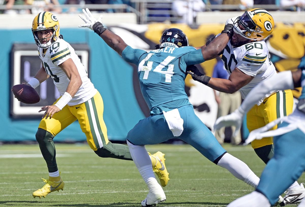 Oct 27, 2024; Jacksonville, Florida, USA; Green Bay Packers quarterback Jordan Love (10) scrambles as Jacksonville Jaguars defensive end Travon Walker (44) pursues during the first half at EverBank Stadium. Mandatory Credit: Melina Myers-Imagn Images
