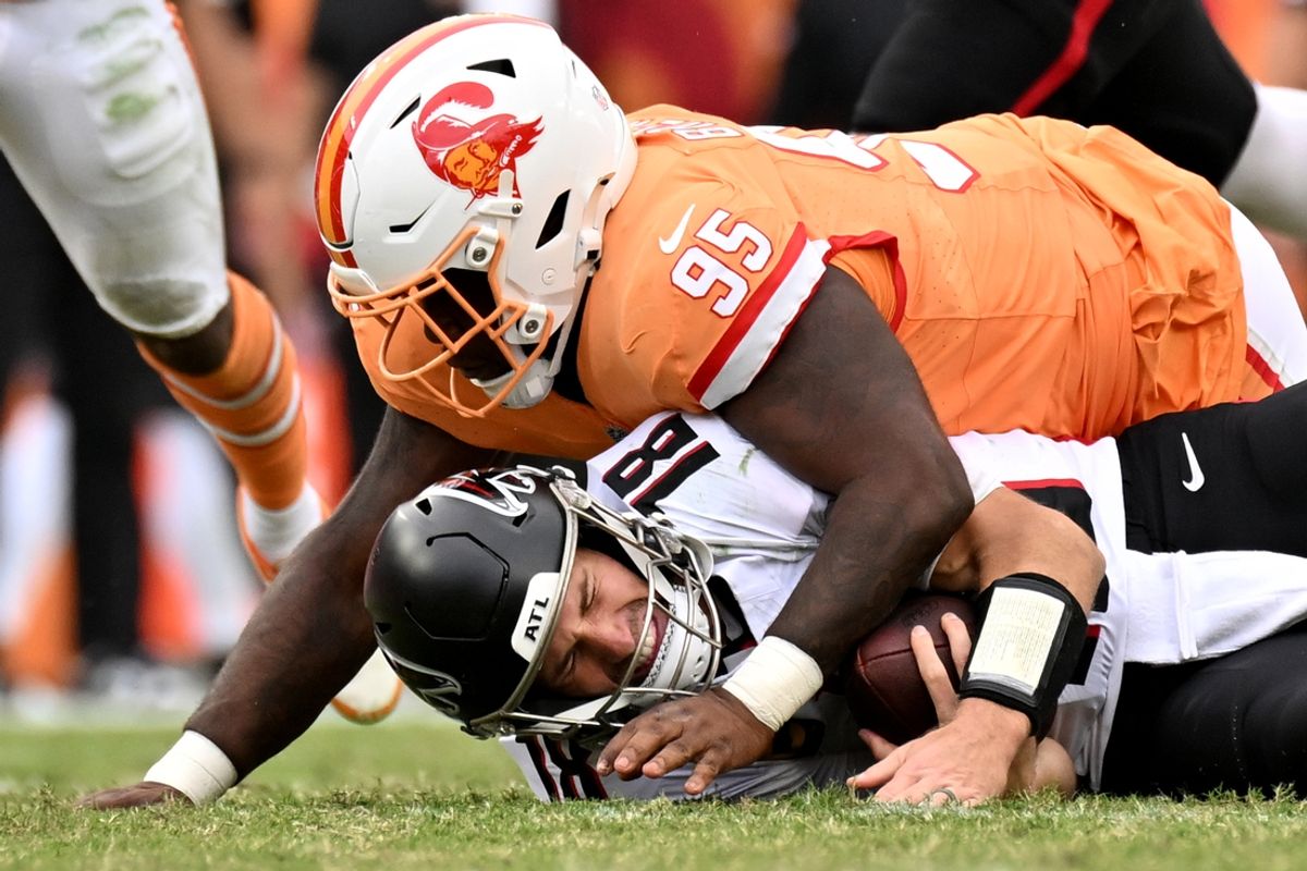 Oct 27, 2024; Tampa, Florida, USA; Atlanta Falcons quarterback Kirk Cousins (18) gets sacked by C.J. Brewer (95)in the second  half at Raymond James Stadium. Mandatory Credit: Jonathan Dyer-Imagn Images