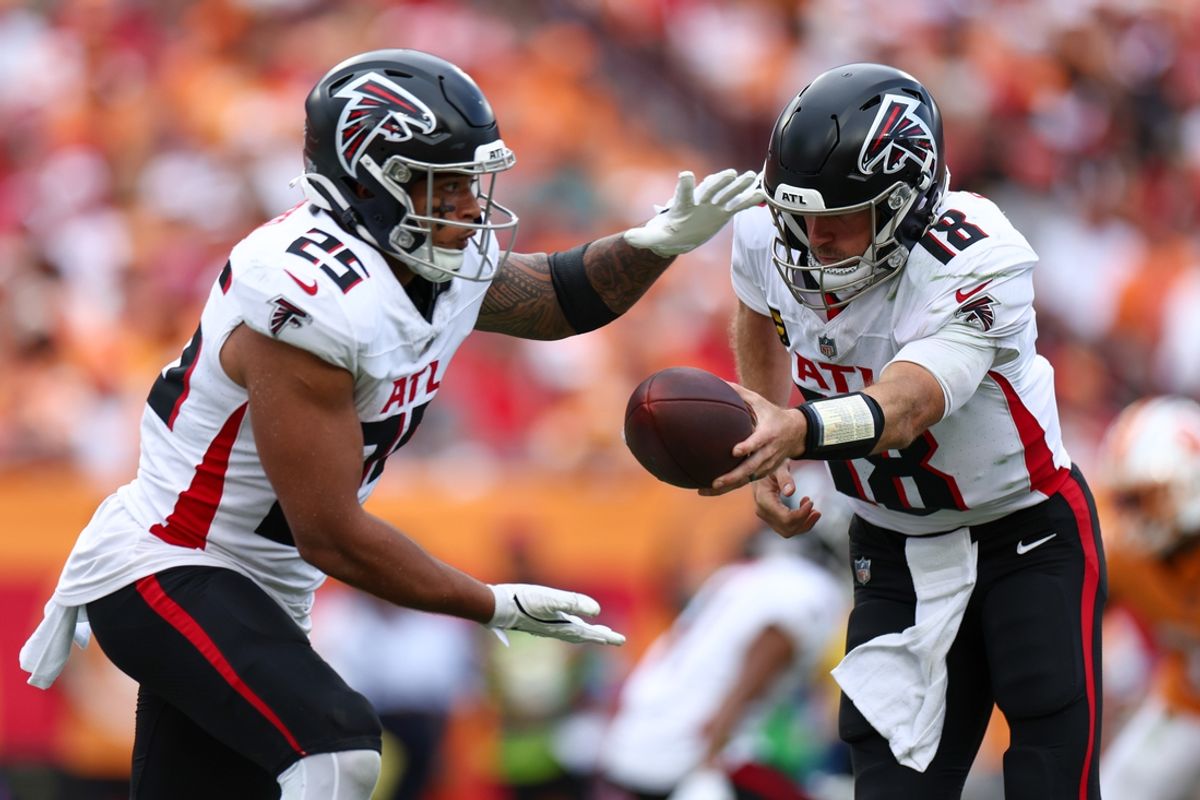 Oct 27, 2024; Tampa, Florida, USA; Atlanta Falcons quarterback Kirk Cousins (18) hands off to running back Tyler Allgeier (25) against the Tampa Bay Buccaneers in the fourth quarter at Raymond James Stadium. Mandatory Credit: Nathan Ray Seebeck-Imagn Images