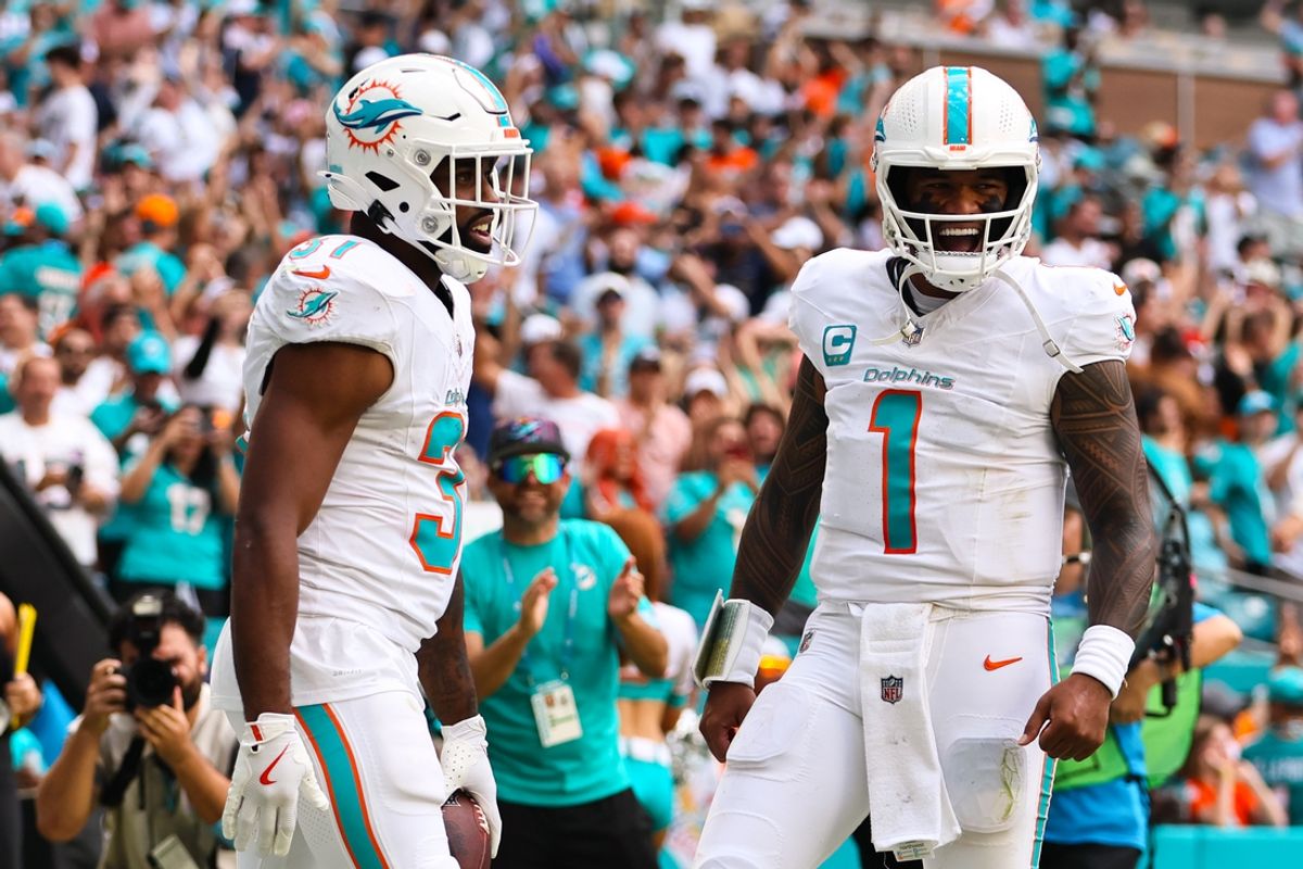 Oct 27, 2024; Miami Gardens, Florida, USA; Miami Dolphins running back Raheem Mostert (31) celebrates with quarterback Tua Tagovailoa (1) after scoring a touchdown against the Arizona Cardinals at Hard Rock Stadium. Mandatory Credit: Sam Navarro-Imagn Images