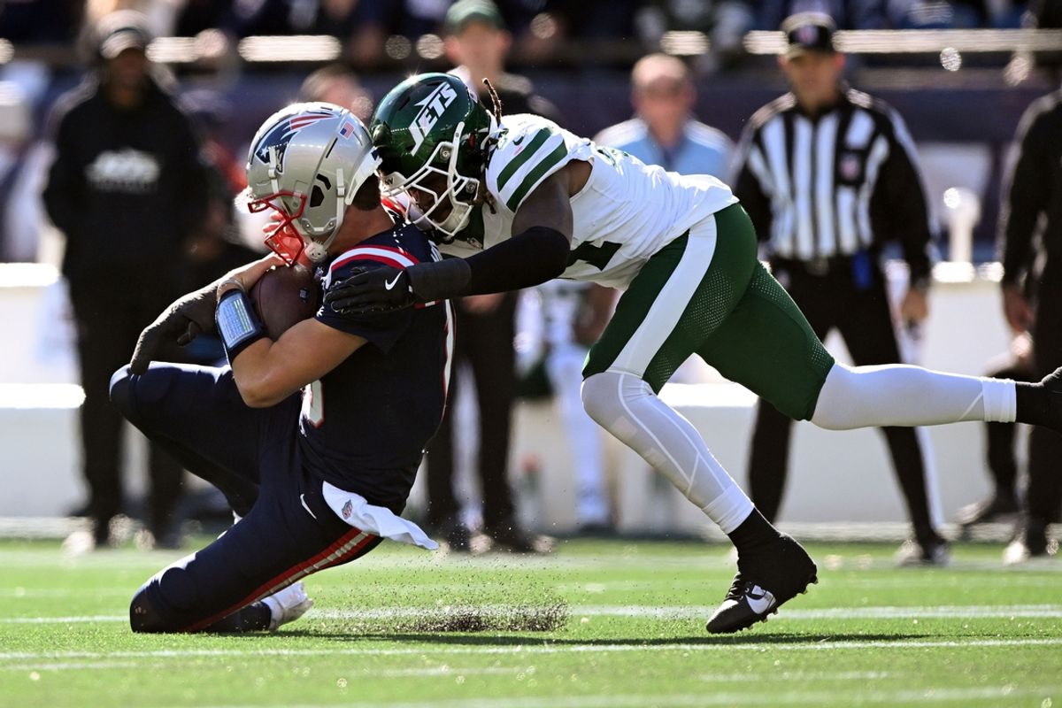 Oct 27, 2024; Foxborough, Massachusetts, USA; New England Patriots quarterback Drake Maye (10) is tackled by New York Jets linebacker Jamien Sherwood (44) during the first half at Gillette Stadium. Mandatory Credit: Brian Fluharty-Imagn Images