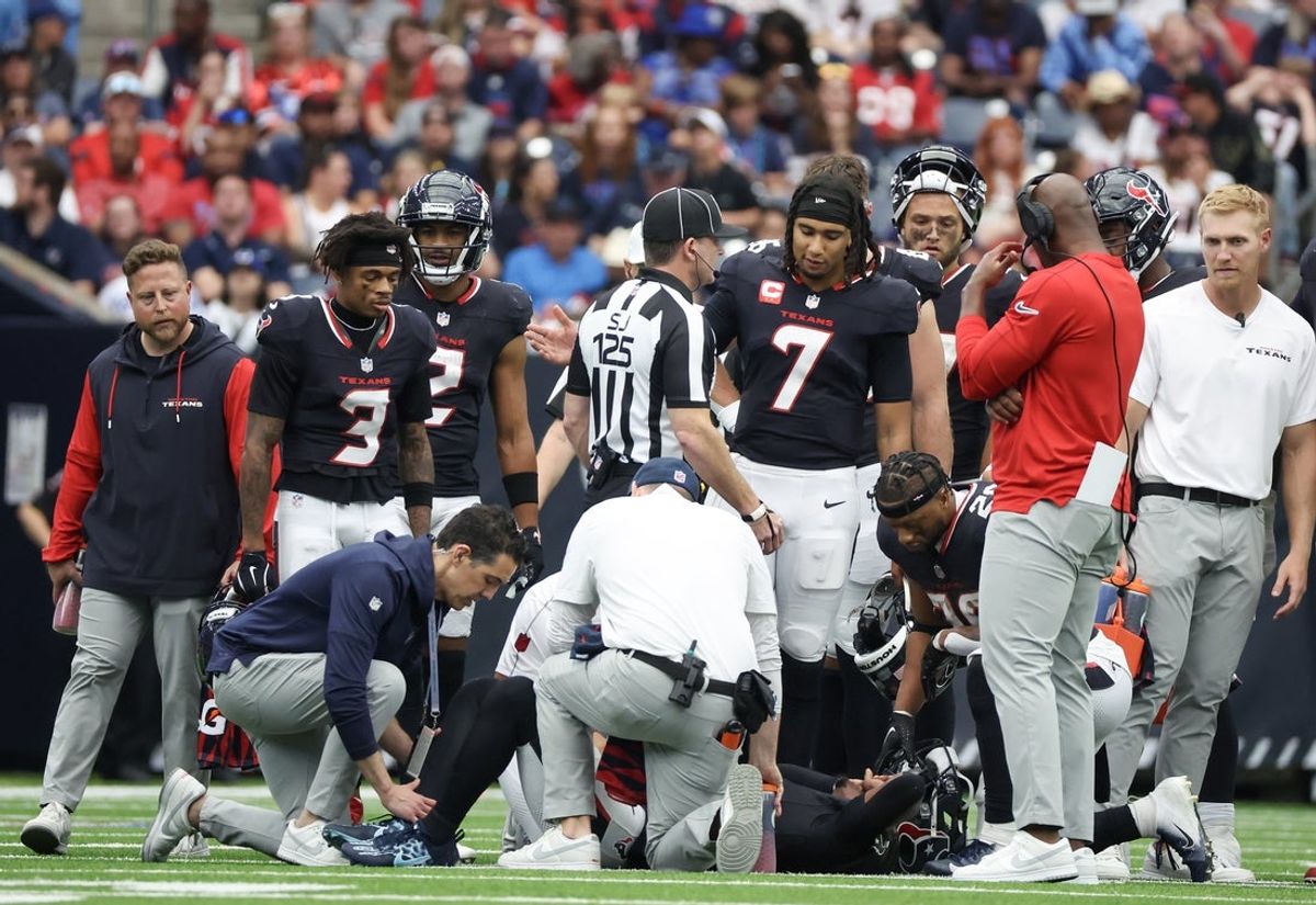 Oct 27, 2024; Houston, Texas, USA; Houston Texans head coach DeMeco Rynas , quarterback C.J. Stroud (7) and wide receiver Tank Dell (3) look down on an injured  wide receiver Stefon Diggs (1) against the Indianapolis Colts in the second half at NRG Stadium. Mandatory Credit: Thomas Shea-Imagn Images