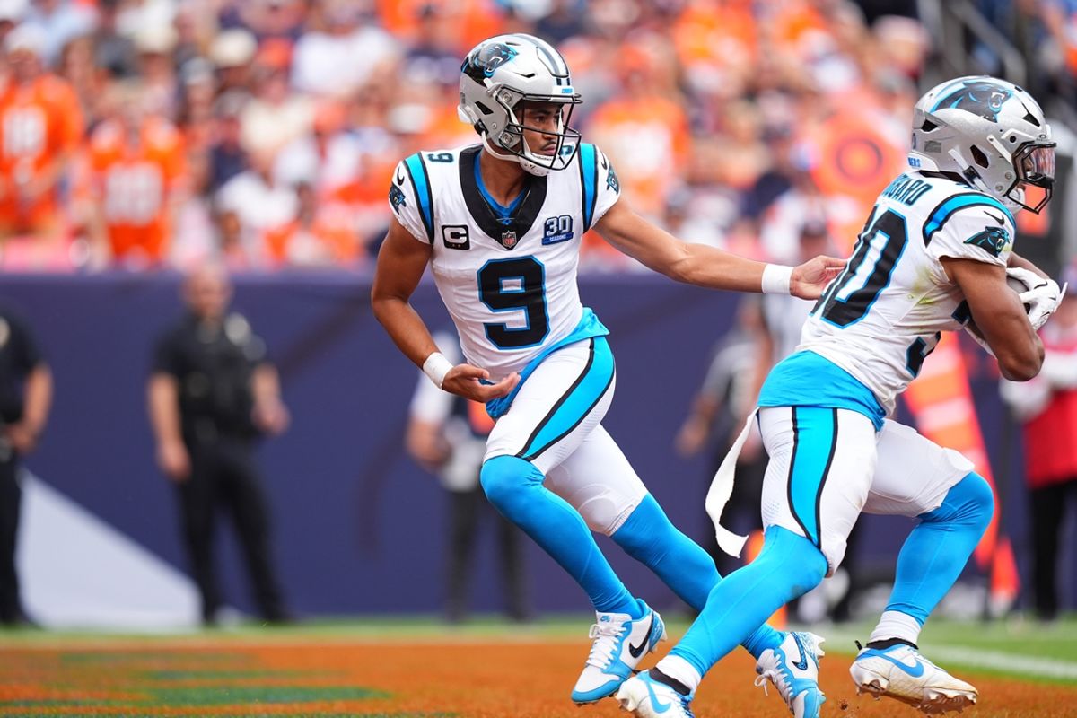 Oct 27, 2024; Denver, Colorado, USA;Carolina Panthers quarterback Bryce Young (9) hands the ball off to running back Chuba Hubbard (30) in the first half against the Denver Broncos at Empower Field at Mile High. Mandatory Credit: Ron Chenoy-Imagn Images
