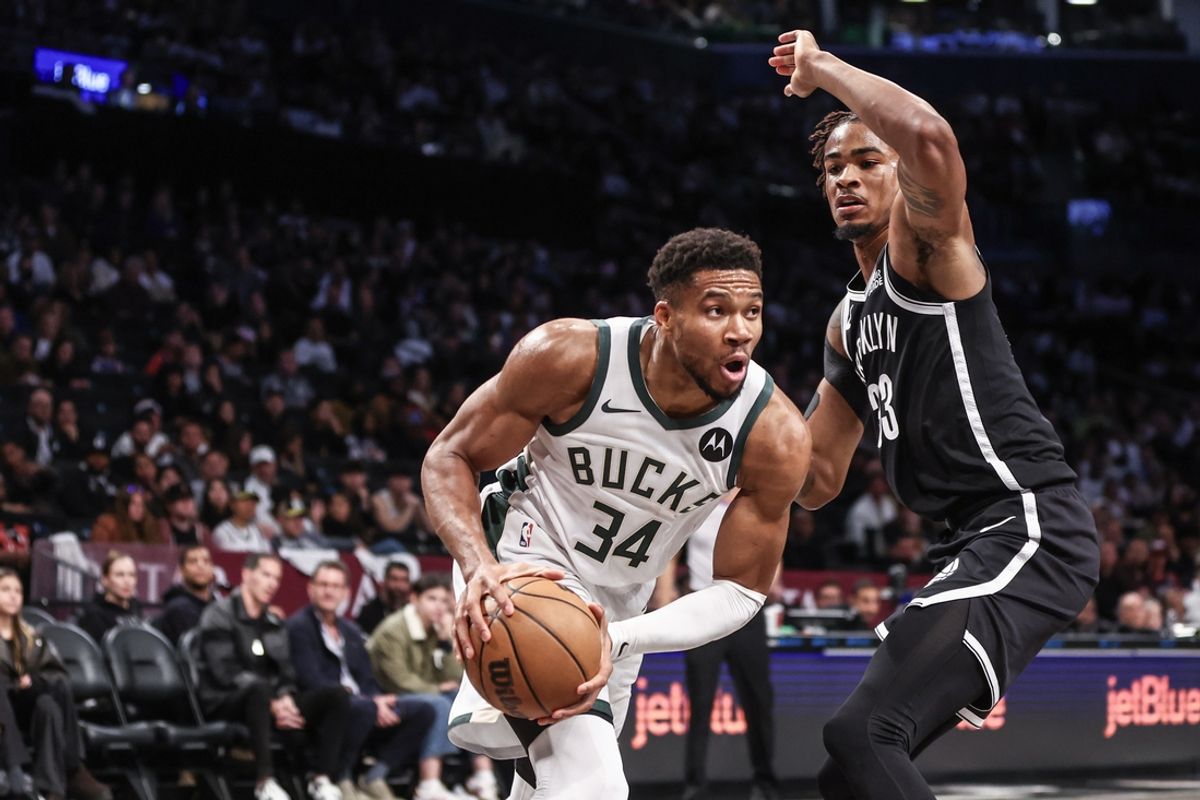 Oct 27, 2024; Brooklyn, New York, USA;  Milwaukee Bucks forward Giannis Antetokounmpo (34) looks to drive past Brooklyn Nets center Nic Claxton (33) in the second quarter at Barclays Center. Mandatory Credit: Wendell Cruz-Imagn Images