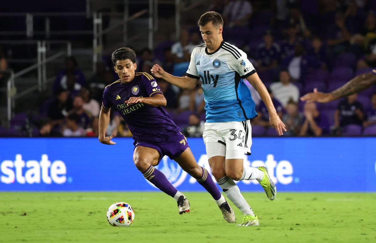 Oct 27, 2024; Orlando, Florida, USA; Orlando City forward Ramiro Enrique (7) and Charlotte FC midfielder Andrew Privett (34) chase a loose ball during the first half in a 2024 MLS Cup Playoffs Round One match at Inter&Co Stadium. Mandatory Credit: Kim Klement Neitzel-Imagn Images